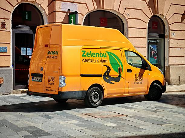 Bratislava, Slovakia - 2nd May, 2025: Nissan e-NV200 Voltia in electric postal delivery van version stopped on a street. This model is one of the most popular zero-emission LCV vehicles in Europe.
