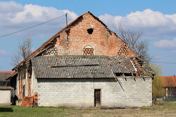 An old 19th century barn in an English farmyard in spring.