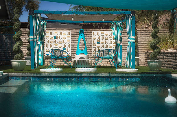 Daytime Desert Oasis Pool with Mid-Century Fireplace and Lounge Area