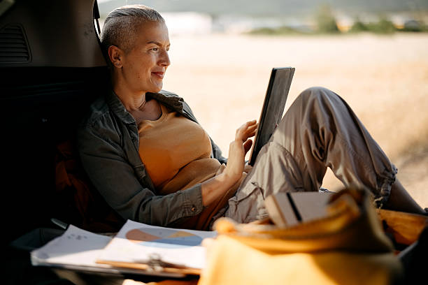 istock Smiling woman using tablet outside next to wheat field 2222776552