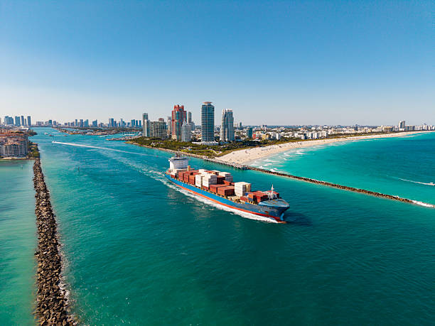 Freight container loaded on cargo vessel. Aerial view cargo ship leaving harbor. Cargo business. Container ship. Shipping logistics. Commercial shipping. Cargo ship in sea, aerial view