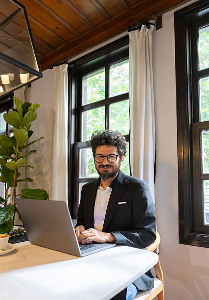 istock Confident businessman working remotely from cozy cafe 2222780507