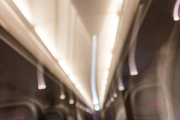 Dynamic and abstract image taken inside an airplane cabin, capturing a swirl of light trails and blurred motion. The photo evokes a surreal, dreamlike atmosphere often experienced during air travel.