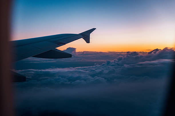 istock Airplane Wing Above Clouds at Sunset 2222783434