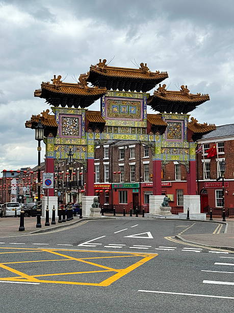 Liverpool, England, United Kingdom - May 05, 2025: Front view of the Chinatown gate in Liverpool under a cloudy sky — marking the entrance to the city’s historic Chinese district.