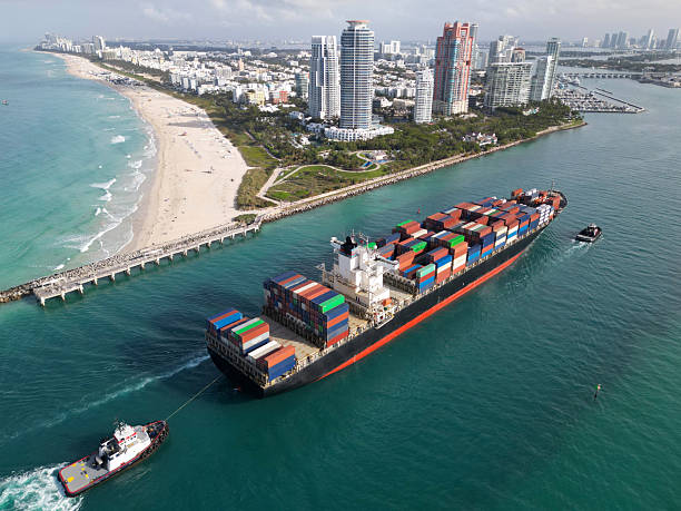 istock Freight container cargo vessel. Cargo ship vessel leaving port. Container ship. Export and import. Cargo business. Port of Miami. Cargo ship with container in Miami, aerial view. Massive steel hull 2222788733