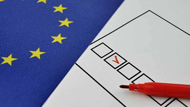 istock Voter selects candidate with red marker on ballot 2222790563