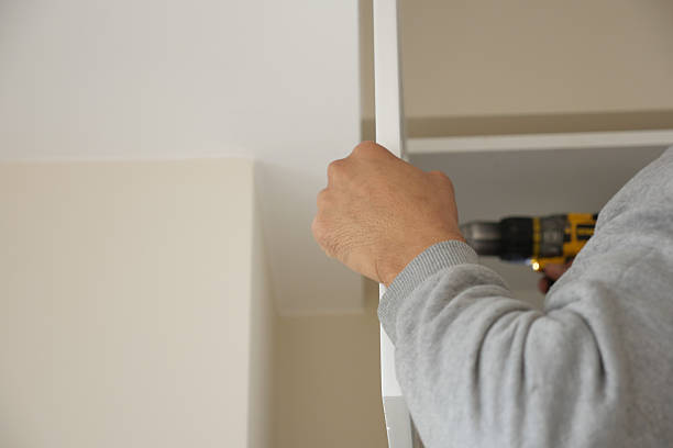 istock Person assembling furniture with power drill in modern interior 2222793270