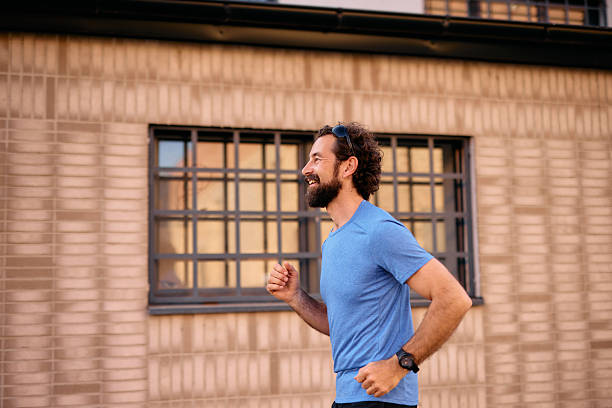 istock Man jogging outside enjoying exercise in the city 2222793953