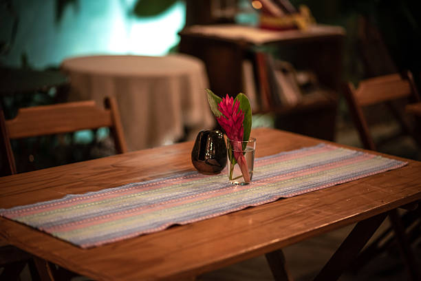 Table setting with white ceramic plate and white table cloth. Dining out in the fancy restaurant. Beautiful hot summer day. Closeup. Side view. Selective focus
