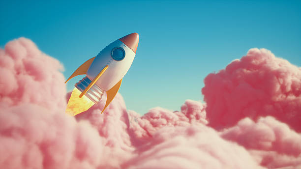 A retro-style rocket ascends above pink clouds, symbolizing a new business launch, innovation, and success. A conceptual image for growth and ambition.