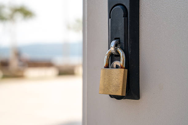 istock Secure brass padlock on outdoor metal gate 2222805978