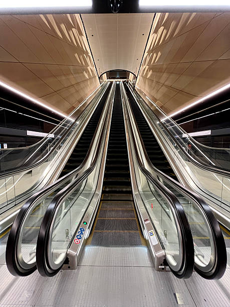 istock A spacious modern hall with towering sandstone walls features three escalators rising through a grand architectural void 2222806027