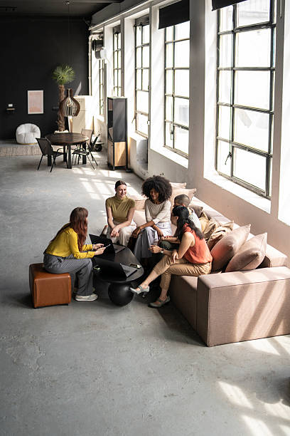istock Coworkers discussing a project in a modern office space, using laptop and tablet 2222806126