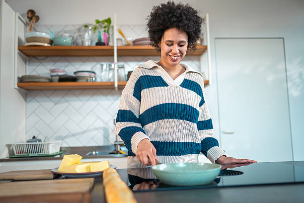 istock Joyful Multiracial Woman Toasting Pine Nuts on Cooktop 2222806835