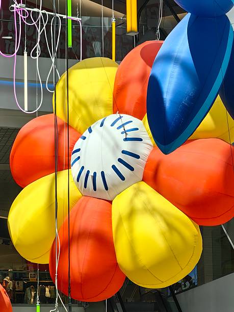 brightly colored inflatable flower installation in modern shopping center creative art elements.