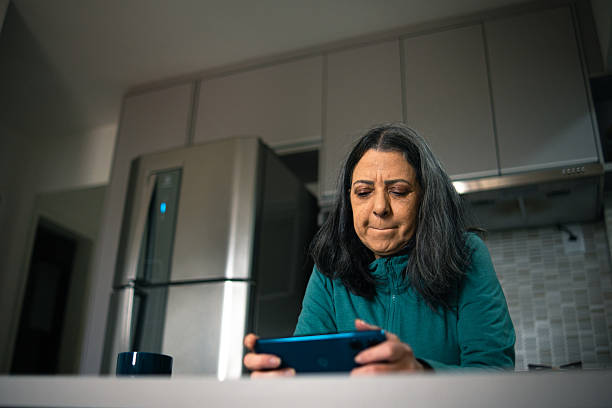 istock Mature woman playing a mobile game 2222815021
