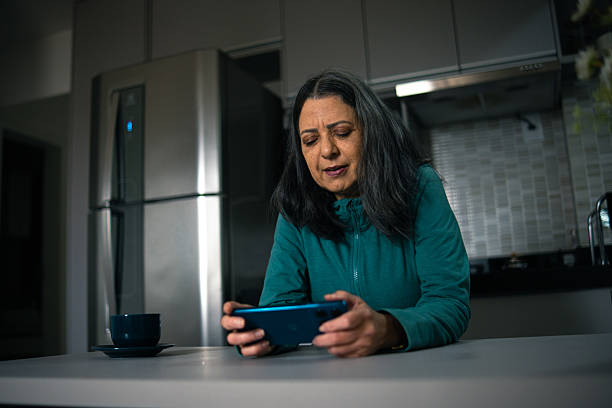 istock Mature woman playing a mobile game 2222815034