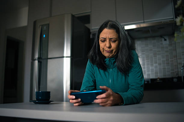 istock Mature woman playing a mobile game 2222815036