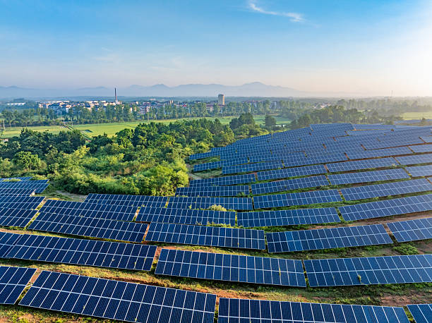 istock Solar photovoltaic panels on a hillside at sunrise 2222819065