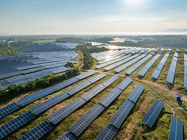 istock Solar photovoltaic panels on a hillside at sunrise 2222819221