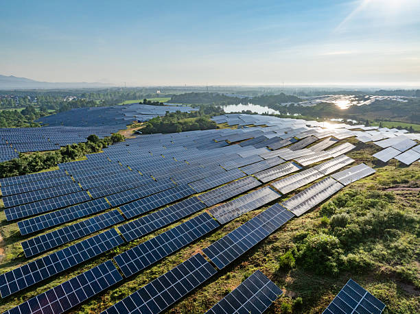 istock Solar photovoltaic panels on a hillside at sunrise 2222819227