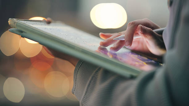 istock asian woman using mobile phone and tablet in tech-forward exploring ai assistant futuristic lifestyle on smartphone and digital tablet, symbolizing human-ai interaction and mobile computing 2222819346
