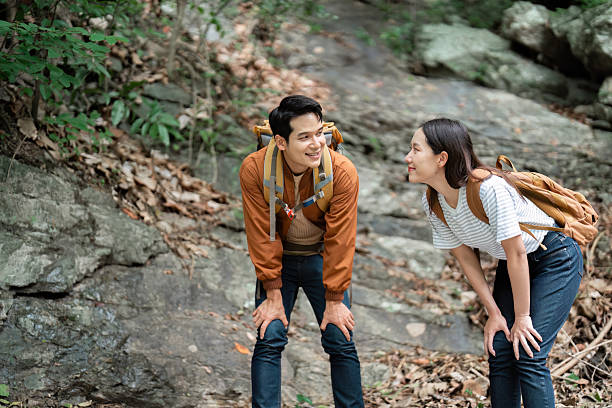 istock Hiking Excursion. Friends take a break on a rocky path surrounded by nature. 2222824661