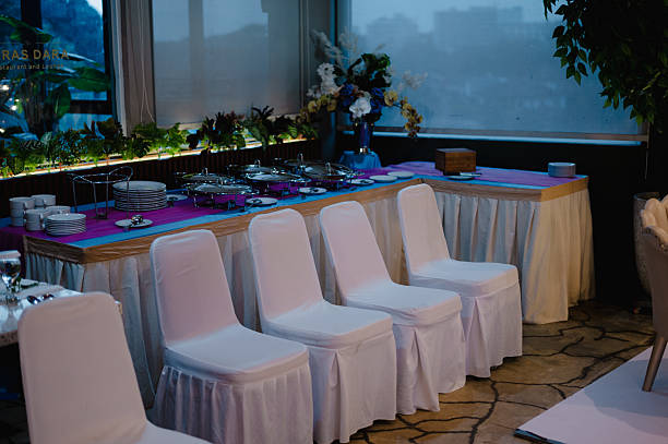 istock Elegant dinner reception setup with white chairs and a buffet table in a banquet hall 2222825132
