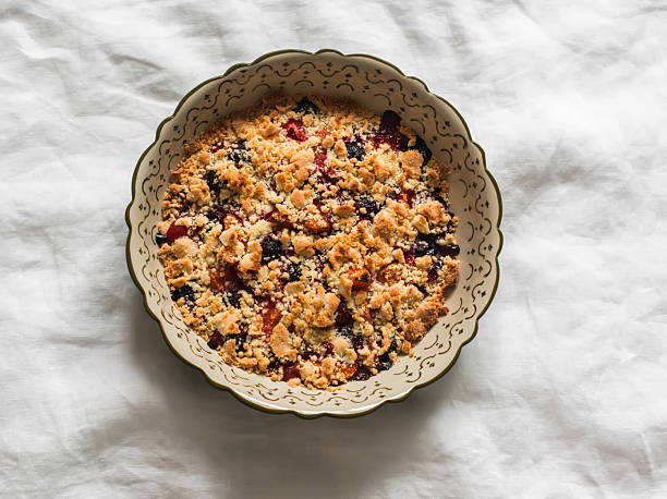 istock Apricots, cherries, strawberries crumble in a baking dish on a light background, top view 2222825523