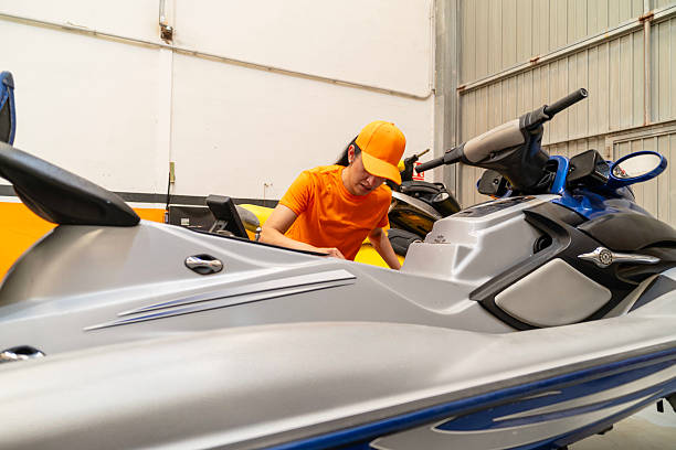 istock Female mechanic examining a jet ski in a workshop 2222827889