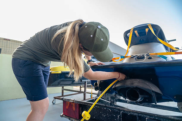 istock Female mechanic fixing jet ski engine in workshop 2222827919