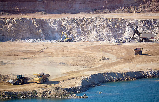 Extraction of natural gypsum rock for the production of building gypsum. Mineral quarry, open-pit gypsum rock mining, equipment and machinery. Shot on a sunny summer day, Astrakhan region