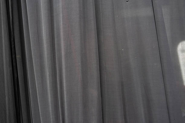 istock Textured gray curtain material displaying vertical lines with soft lighting and subtle folds 2222831675