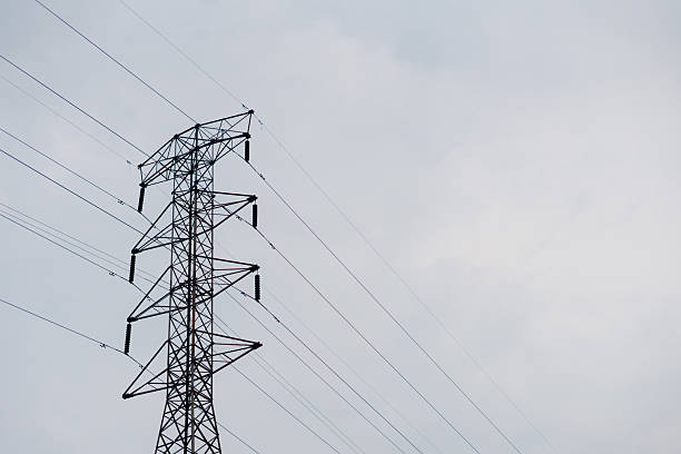 istock High-voltage power tower silhouette against a cloudy sky, electricity transmission concept 2222831676