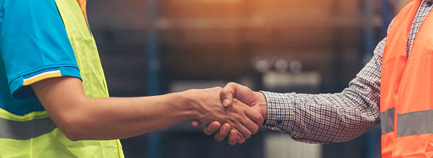 istock Banner Asian Teamwork Warehouse worker shakehand together. Engineer man, women handshake partnership. Coworker colleague logistics Warehouse teams. Team person shaking hand partner with copy space 2222831843