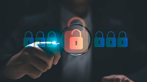 istock Cybersecurity concept showing a security analyst detecting a data breach. A businessman uses a magnifying glass to identify an unlocked padlock among secure digital locks. 2222832888