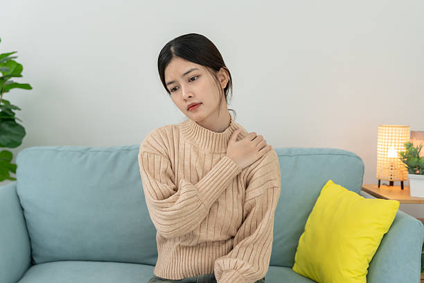 istock woman holding on shoulder and while and suffer from unbearable pain health and problems, chronic shoulder pain, shoulder ache in office syndrome, scoliosis, herniated disc, muscle inflammation 2222833600
