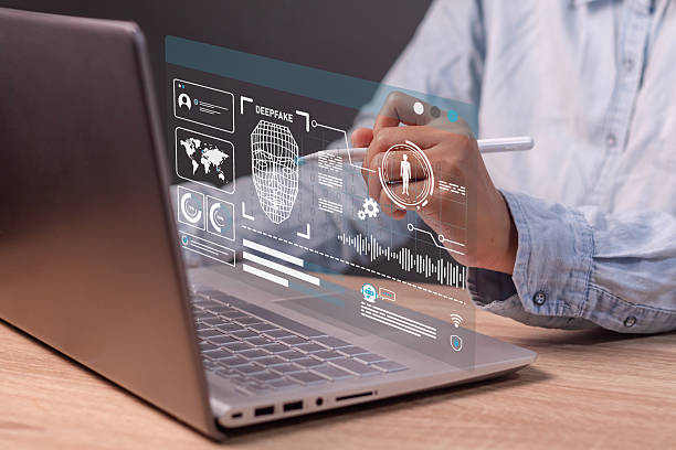 istock Deepfake and artificial intelligence concept. Woman using laptop to create convincing fake image, video and audio recording. 2222834241