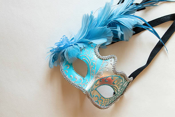 Italy Venice, female wearing a fancy carnaval mask with blue eyes