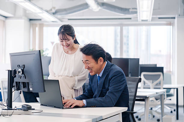 istock Boss and young woman having fun in the office 2222840053