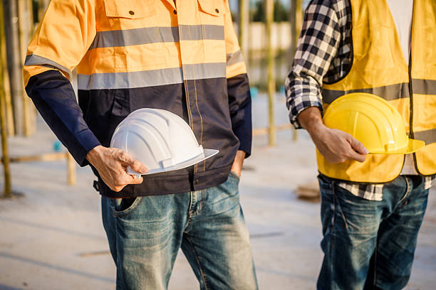 istock An elderly engineer and a middle-aged man at a construction site engage in a serious discussion one placing  shoulder, symbolizing guidance, mentorship, and on-site professional collaboration 2222842143
