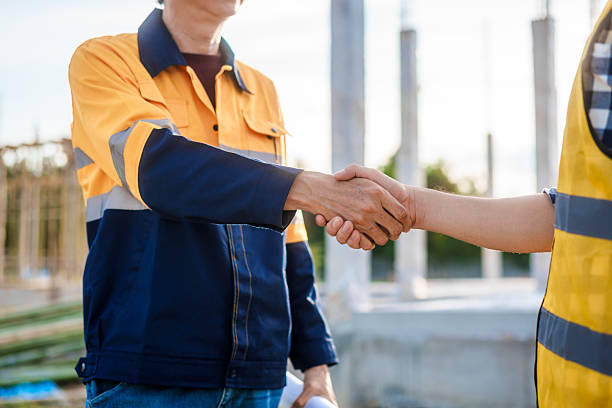 istock An elderly engineer and a middle-aged man shake hands at a construction site, symbolizing mutual respect, collaboration,professional commitment in engineering and construction project environments 2222842529