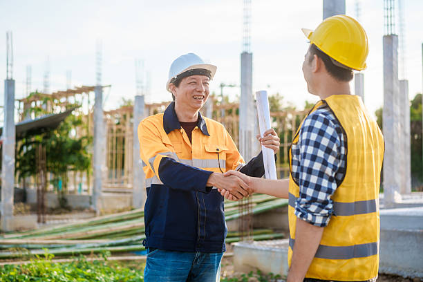 istock An elderly engineer and a middle-aged man shake hands at a construction site, symbolizing mutual respect, collaboration,professional commitment in engineering and construction project environments 2222843381