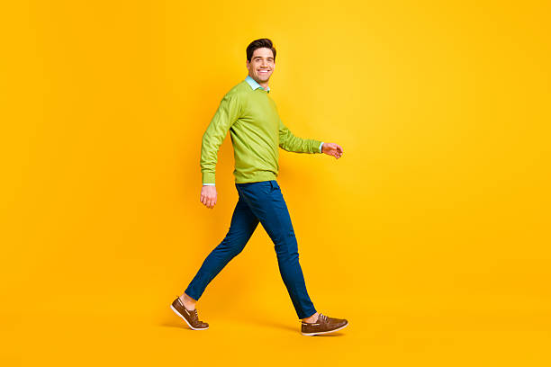 istock Full length body size profile side view of attractive content cheerful guy executive manager walking isolated over bright yellow color background 2222843454