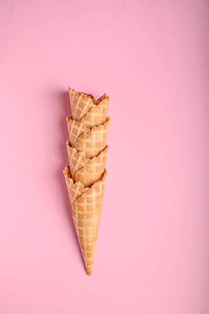 istock Four crispy waffle cones are neatly stacked against a soft pink backdrop, perfect for serving ice cream during a warm summer day 2222844973