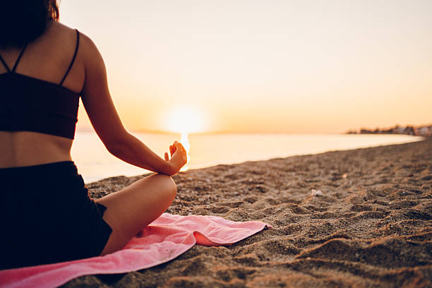 istock Woman exercising on the sea 2222849593