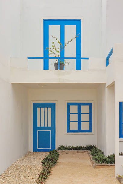 istock Charming Mediterranean Architecture: Blue Accents on White Building with Peaceful Courtyard Design 2222850287