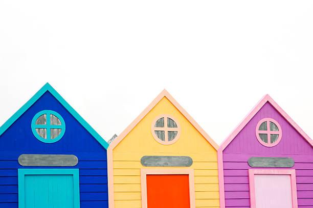 istock Three Colorful Beach Huts in a Row Against a Bright White Sky, Perfect for Summer Vacation 2222850784