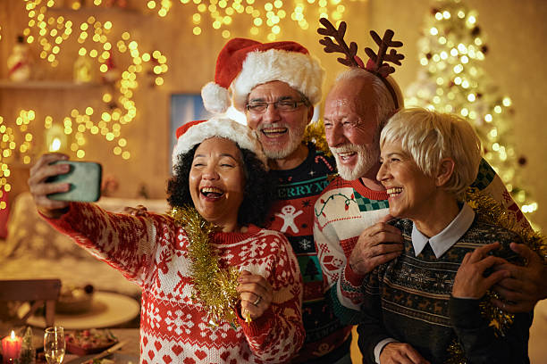 istock Happy senior couples taking a selfie with cell phone on Christmas. 2222853001